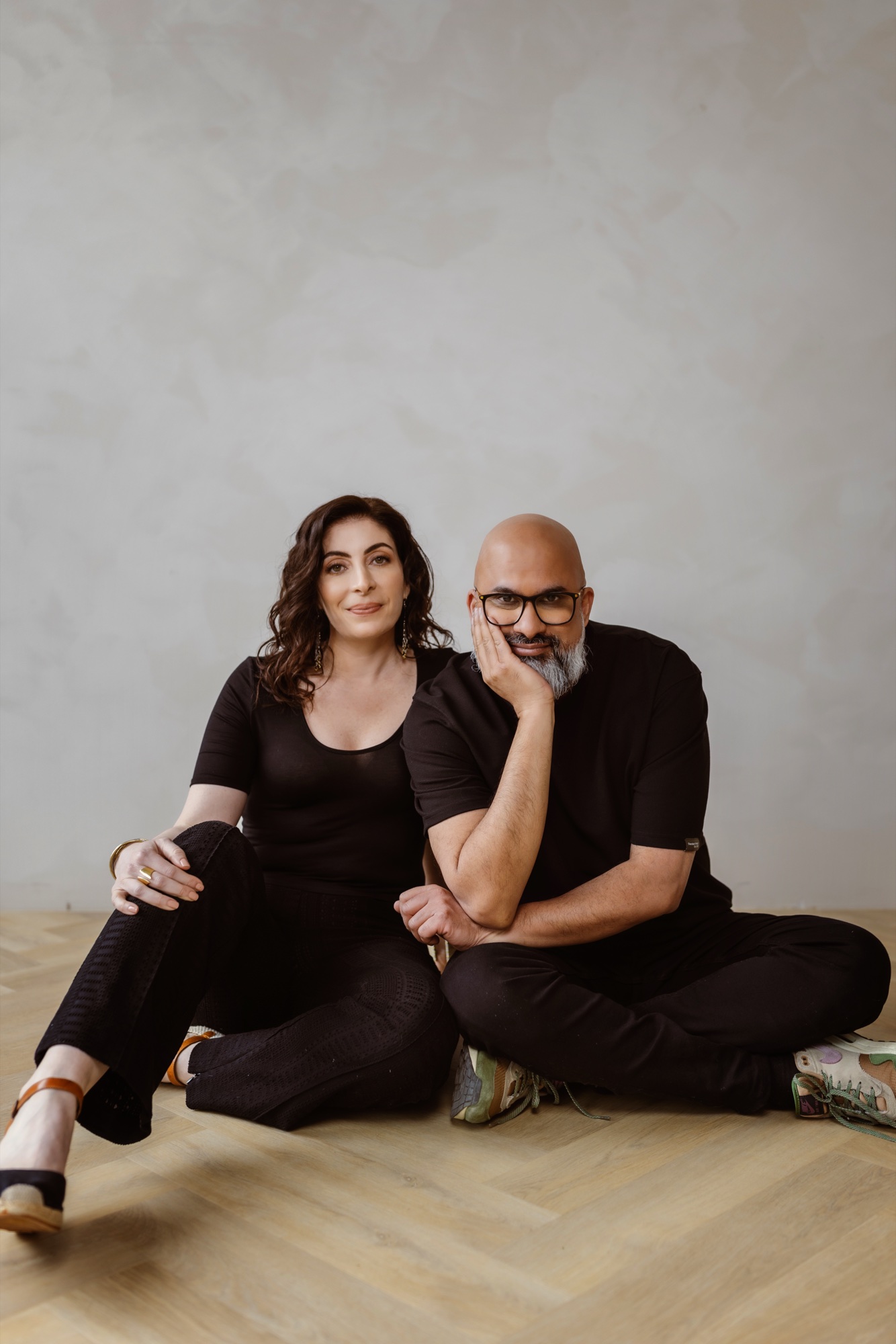 Jennifer Spencer and Steve Fernandez seated together on the studio floor