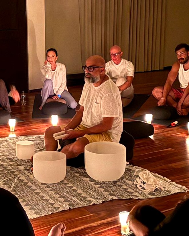 Steve Fernandez leading a candlelit sound bath