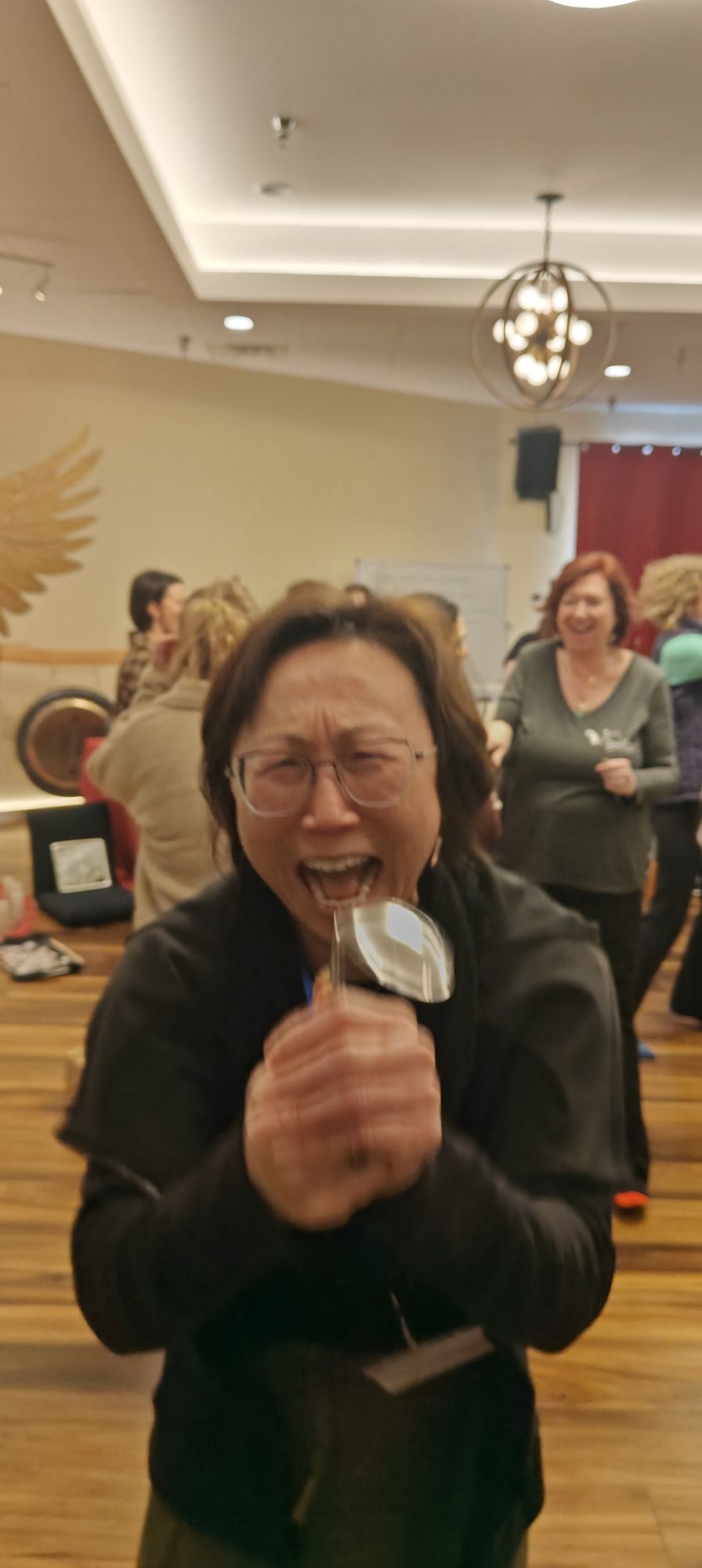 A guest laughing, spoon in hand