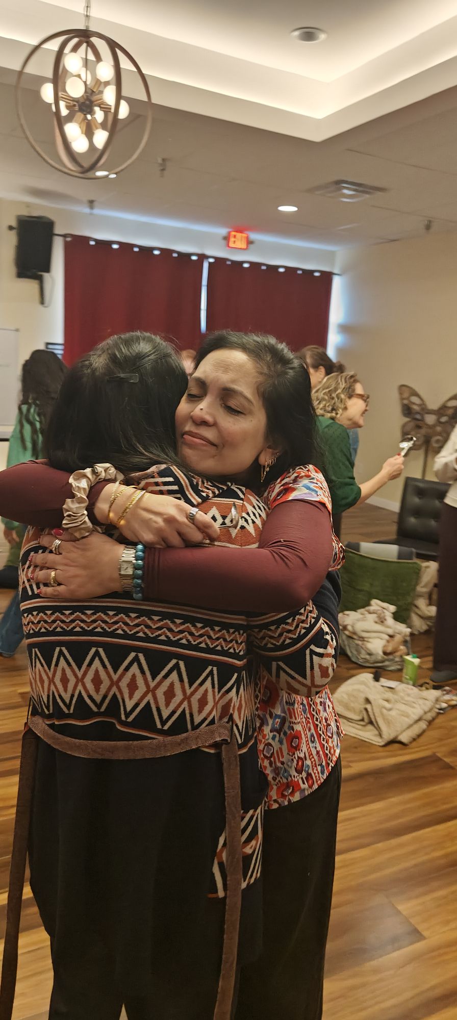 Two guests holding each other after a session
